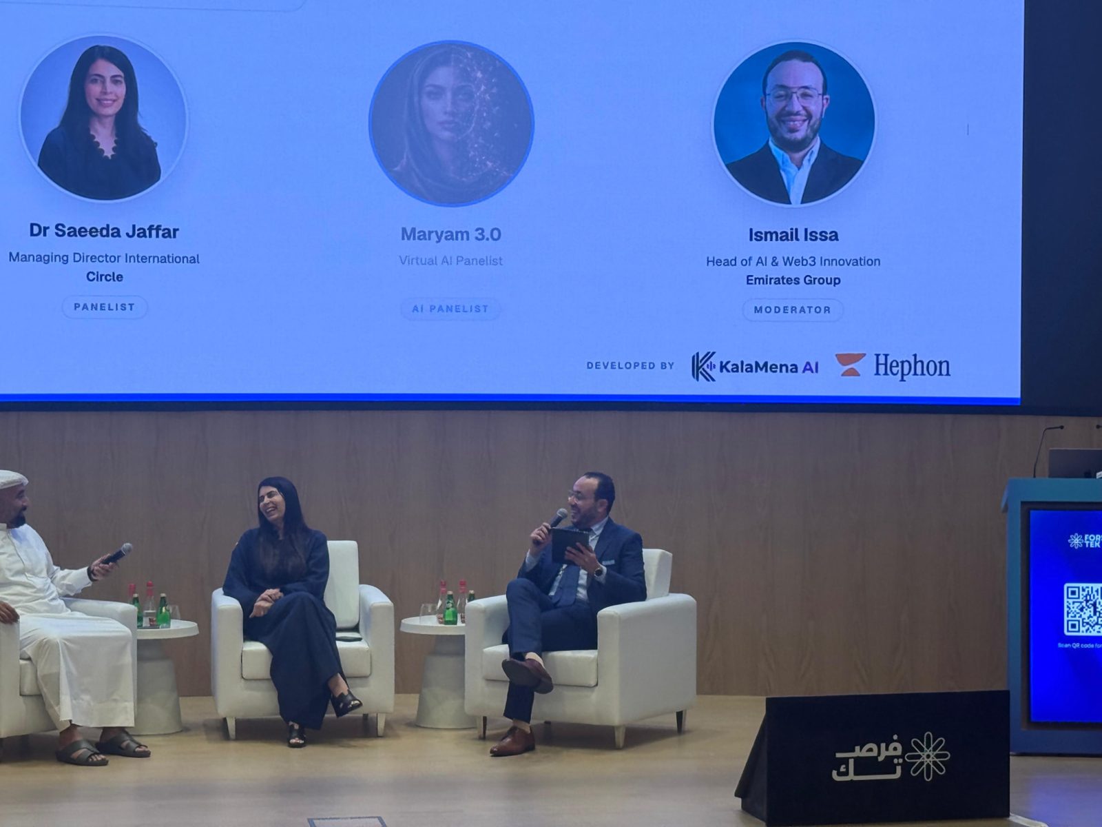 Emirates Group ForsaTEK AI panel on stage, with Maryam 3.0 shown on the screen as a virtual AI panelist